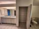 Bathroom with vanity, linen closet, and toilet at 23104 Rountree Ave, Port Charlotte, FL 33980