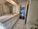 Bathroom with vanity and view to hallway at 23104 Rountree Ave, Port Charlotte, FL 33980