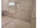 Walk-in shower with grab bars and hexagon floor tiles at 23104 Rountree Ave, Port Charlotte, FL 33980