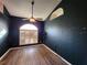 Dark blue bedroom with wood flooring and large window at 23104 Rountree Ave, Port Charlotte, FL 33980