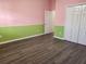 Bright bedroom with wood-look floors and ceiling fan at 23104 Rountree Ave, Port Charlotte, FL 33980