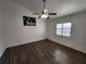 Spacious bedroom with dark laminate flooring and a ceiling fan at 23104 Rountree Ave, Port Charlotte, FL 33980