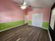 Bright bedroom with wood-look floors and ceiling fan at 23104 Rountree Ave, Port Charlotte, FL 33980