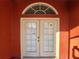 Double front doors with arched window, leading into the house at 23104 Rountree Ave, Port Charlotte, FL 33980