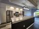 Modern kitchen with stainless steel appliances and granite countertops at 23104 Rountree Ave, Port Charlotte, FL 33980