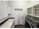 Laundry room with washer, dryer, sink, and ample cabinets at 23104 Rountree Ave, Port Charlotte, FL 33980