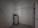 Laundry room with shelving and water heater at 23104 Rountree Ave, Port Charlotte, FL 33980