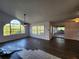 Living room with vaulted ceiling, wood flooring, and access to patio at 23104 Rountree Ave, Port Charlotte, FL 33980