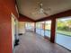 Spacious screened porch with tile flooring and ceiling fan at 23104 Rountree Ave, Port Charlotte, FL 33980