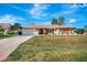 Single-story home with a large yard, driveway, and attached garage at 2321 Sofia Ln, Punta Gorda, FL 33983