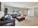 Living room with a brown leather sectional and a large window at 2321 Sofia Ln, Punta Gorda, FL 33983