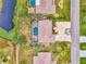 Aerial view of home with pool and canal at 24 Oakland Hills Ct, Rotonda West, FL 33947
