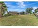 Large backyard with a view of the pool and golf course at 24 Oakland Hills Ct, Rotonda West, FL 33947