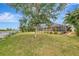 Spacious backyard with screened enclosure and lush lawn at 24 Oakland Hills Ct, Rotonda West, FL 33947