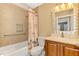 Bathroom with tub shower combo and granite vanity at 24 Oakland Hills Ct, Rotonda West, FL 33947