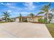 Single-story home with two-car garage and landscaping at 24 Oakland Hills Ct, Rotonda West, FL 33947