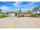 Single-story home with two-car garage and landscaping at 24 Oakland Hills Ct, Rotonda West, FL 33947