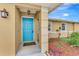 Welcoming teal front door with a covered entryway at 24 Oakland Hills Ct, Rotonda West, FL 33947