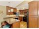 Modern kitchen with dark wood cabinets and granite countertops at 24 Oakland Hills Ct, Rotonda West, FL 33947