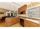 Modern kitchen with wood cabinets and granite countertops at 24 Oakland Hills Ct, Rotonda West, FL 33947