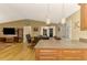 Open concept kitchen and dining area with hardwood floors at 24 Oakland Hills Ct, Rotonda West, FL 33947