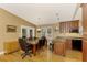 Open concept kitchen and dining area with hardwood floors at 24 Oakland Hills Ct, Rotonda West, FL 33947