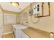 Laundry room with washer, dryer, and shelving at 24 Oakland Hills Ct, Rotonda West, FL 33947