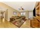 Comfortable living room with hardwood floors and a large TV at 24 Oakland Hills Ct, Rotonda West, FL 33947