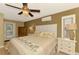 Spacious main bedroom with ceiling fan, private door to outside, and large TV at 24 Oakland Hills Ct, Rotonda West, FL 33947