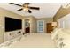 Spacious main bedroom with large TV, private door to outside, and ensuite bathroom at 24 Oakland Hills Ct, Rotonda West, FL 33947