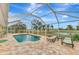 Relaxing screened-in pool area with patio furniture at 24 Oakland Hills Ct, Rotonda West, FL 33947