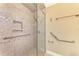 Large accessible shower with grab bars and tiled walls at 24 Oakland Hills Ct, Rotonda West, FL 33947
