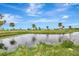 Serene view of a peaceful canal and lush green landscape at 24 Oakland Hills Ct, Rotonda West, FL 33947