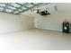 A spacious garage with white epoxy flooring, great for parking and storage at 2400 Carpenter Ln, North Port, FL 34286