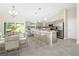 Modern kitchen with grey cabinets, a large center island, stainless steel appliances, and an adjacent dining area at 2400 Carpenter Ln, North Port, FL 34286