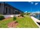 Waterfront backyard with screened-in lanai, lush lawn, mature landscaping, and private dock at 2750 W Marion Ave, Punta Gorda, FL 33950