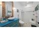 Beach themed bathroom featuring a custom vanity and shower at 2750 W Marion Ave, Punta Gorda, FL 33950