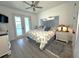 Comfortable bedroom with a queen-sized bed, French doors, and serene decor at 2750 W Marion Ave, Punta Gorda, FL 33950