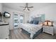 Serene bedroom with private outdoor access, complemented by a charming coastal-themed decor and soft lighting at 2750 W Marion Ave, Punta Gorda, FL 33950