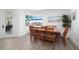 Bright dining room features a wooden table set with seating for six, and serene water views through a large window at 2750 W Marion Ave, Punta Gorda, FL 33950