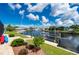 Beautiful waterfront home featuring a private dock, grassy lawn, and attractive landscaping at 2750 W Marion Ave, Punta Gorda, FL 33950