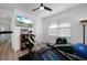 Exercise room with ceiling fan, weights, workout equipment, and a TV at 2750 W Marion Ave, Punta Gorda, FL 33950