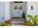 Elegant double front doors with floral wreaths, set off by red flowers and a stone tile entryway at 2750 W Marion Ave, Punta Gorda, FL 33950