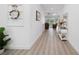 Bright entryway boasts wood-look flooring, coastal decor, and easy access to the living area and outdoor pool at 2750 W Marion Ave, Punta Gorda, FL 33950