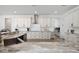 Bright kitchen with stainless steel appliances, marble countertops, and white cabinets featuring black hardware at 2750 W Marion Ave, Punta Gorda, FL 33950