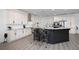 Elegant kitchen with an island, stainless steel appliances, white cabinets and stylish bar stools at 2750 W Marion Ave, Punta Gorda, FL 33950