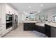 Bright kitchen with stainless appliances, granite counters, black cabinets and an open floor plan at 2750 W Marion Ave, Punta Gorda, FL 33950