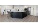 Stylish kitchen with white and black cabinets, stainless steel appliances, and a marble countertop island at 2750 W Marion Ave, Punta Gorda, FL 33950