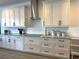 Modern kitchen featuring white cabinets, stainless steel appliances, and granite countertops at 2750 W Marion Ave, Punta Gorda, FL 33950