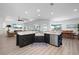 Modern kitchen with a black island, stainless steel sink, and views of the living area and waterfront beyond at 2750 W Marion Ave, Punta Gorda, FL 33950